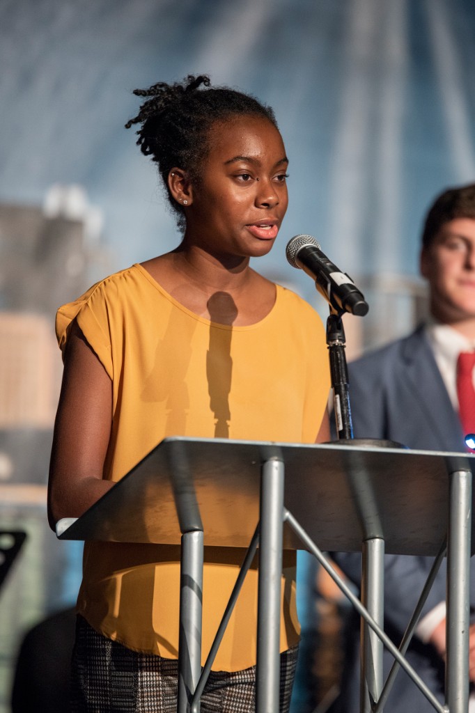 Kori speaking at podium