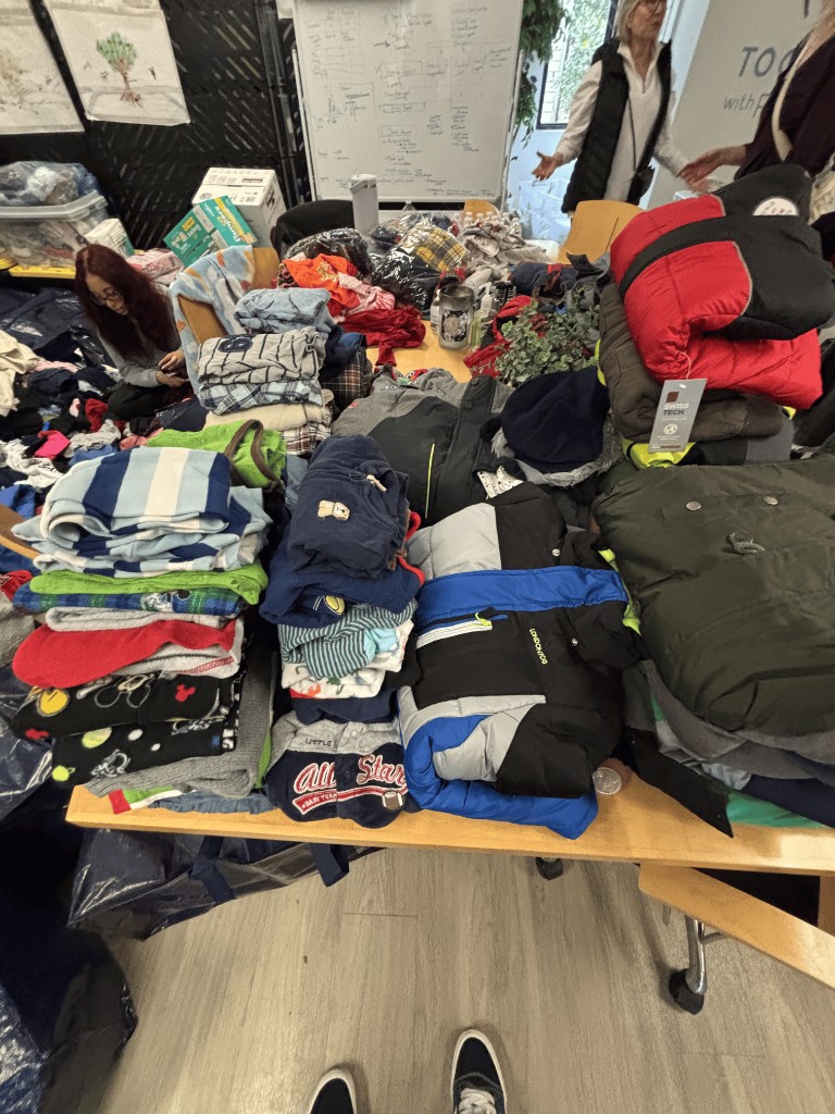 Kori volunteering, folding children's clothes